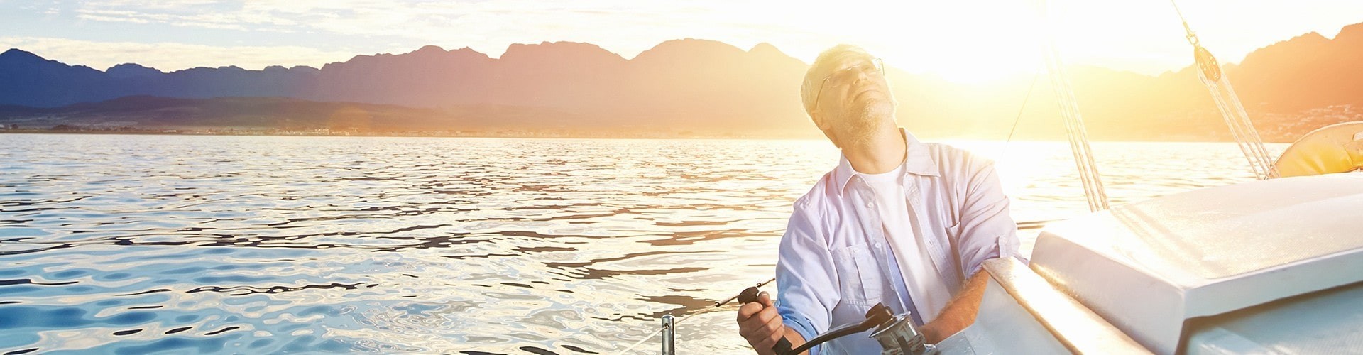 A reverse mortgage helps a senior man enjoying a day on his sailboat in San Diego, CA