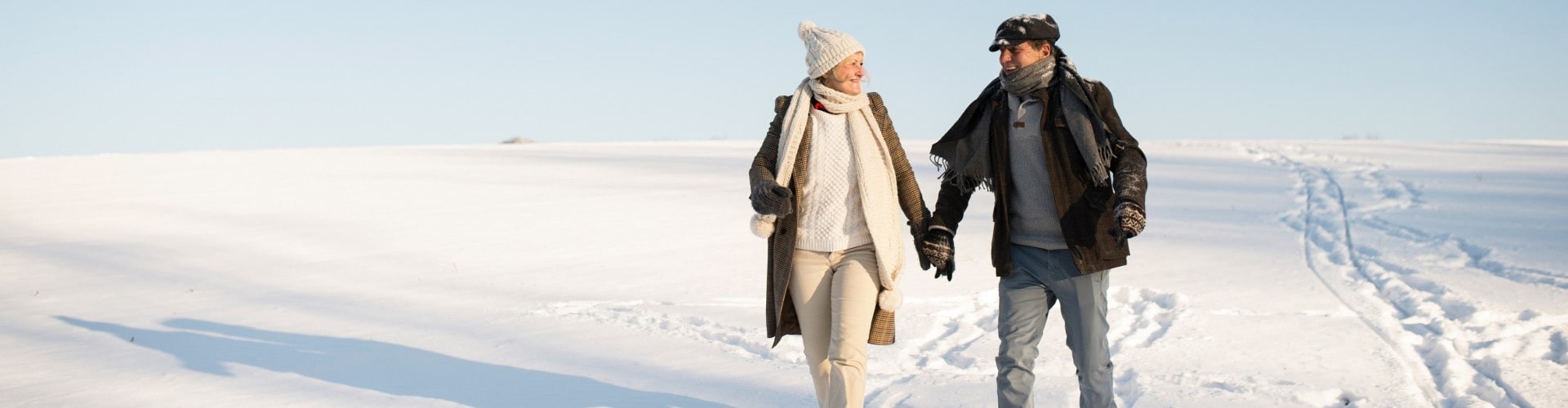 A reverse mortgage makes it possible for a senior couple to walk through the snow